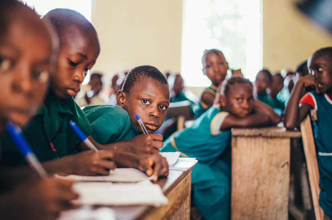 students using laptops in classroom