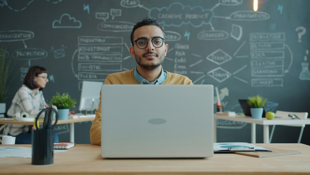 team using laptop in office