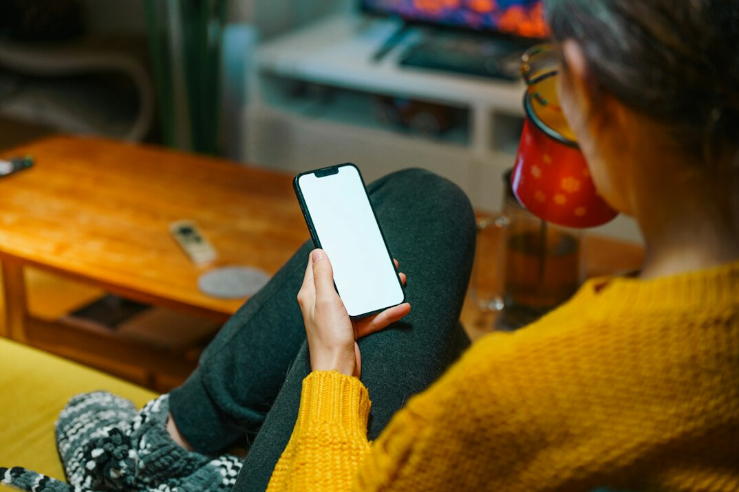person using smartphone at home
